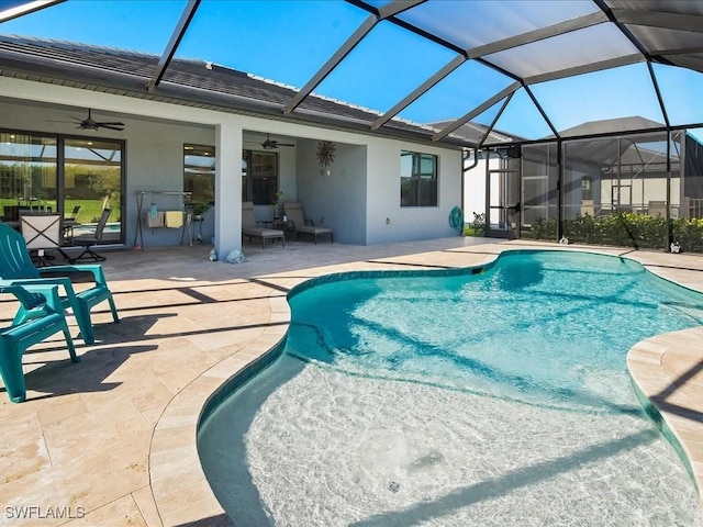 view of pool with ceiling fan, a lanai, and a patio