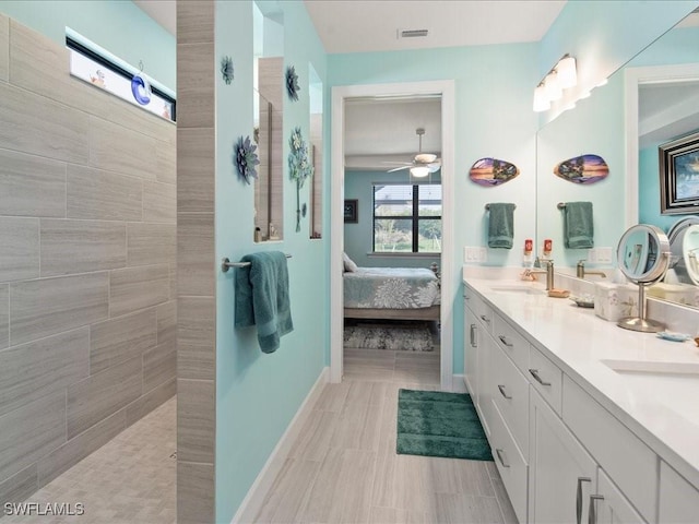 bathroom featuring vanity, ceiling fan, and tiled shower