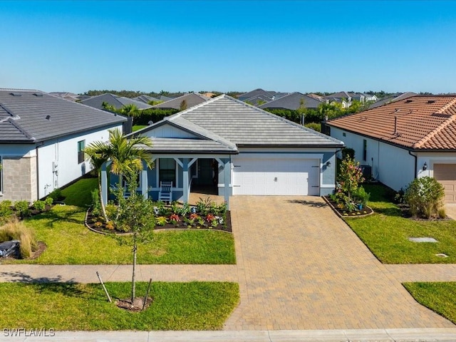 ranch-style house featuring a garage and a front lawn