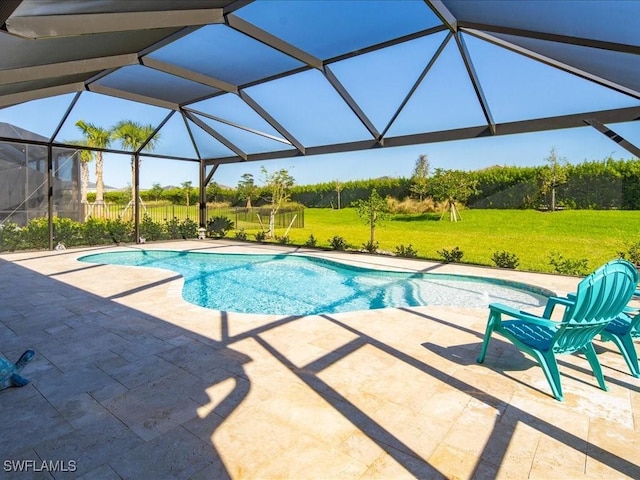 view of pool featuring a lanai, a patio area, and a lawn