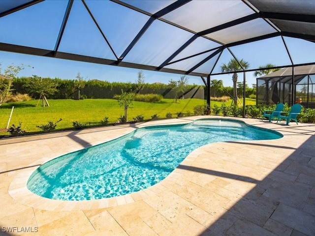 view of swimming pool with a patio area, a yard, and glass enclosure