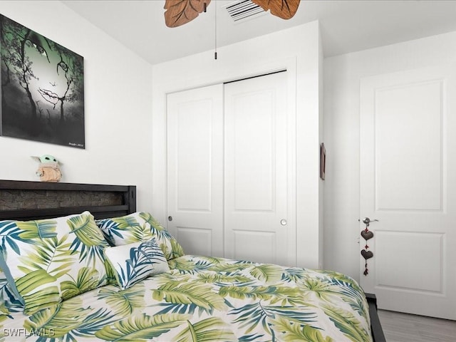 bedroom featuring hardwood / wood-style floors and a closet