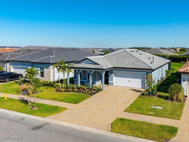 single story home with a garage and a front lawn