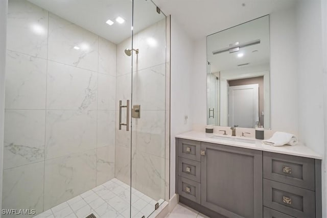 bathroom with vanity and a shower with shower door