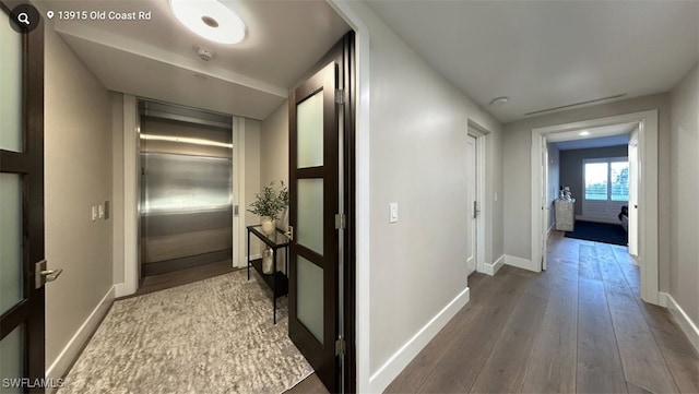 corridor featuring wood-type flooring