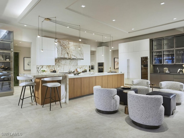 kitchen featuring hanging light fixtures, white cabinetry, and a spacious island