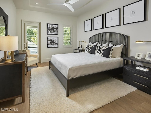 bedroom with light hardwood / wood-style floors and ceiling fan