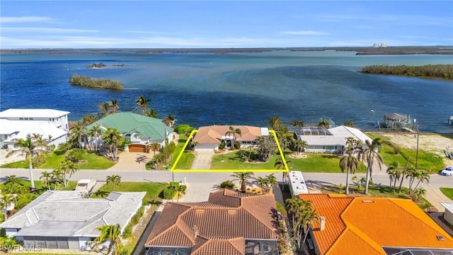 birds eye view of property featuring a water view and a residential view