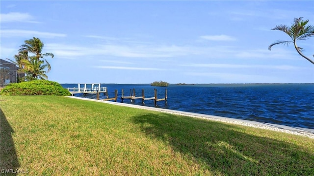 dock area featuring a water view and a lawn