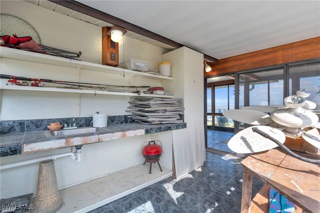 kitchen featuring dark tile patterned flooring and sink