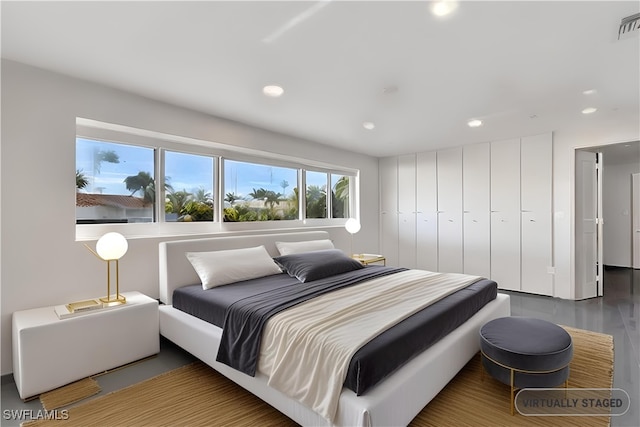 bedroom with hardwood / wood-style floors and a closet