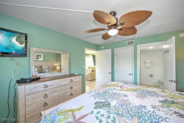 bedroom with ensuite bathroom and ceiling fan