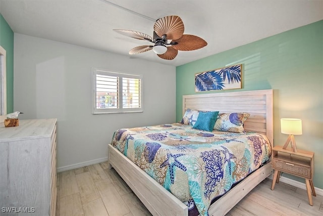 bedroom with ceiling fan and light hardwood / wood-style flooring