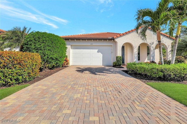 mediterranean / spanish-style home featuring a garage