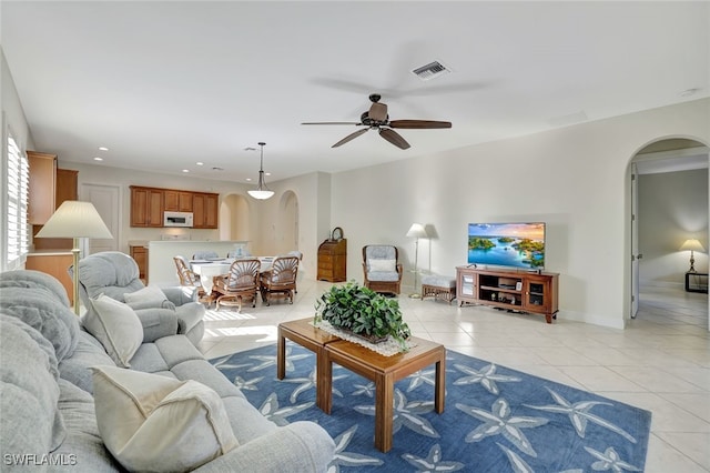 living room featuring ceiling fan and light tile patterned floors