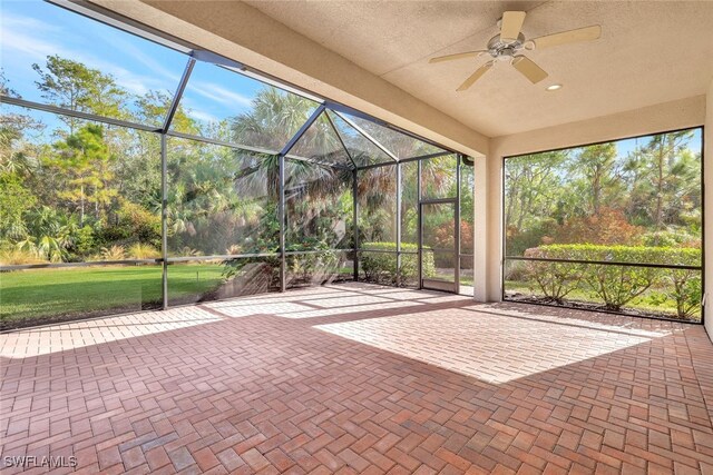 unfurnished sunroom featuring ceiling fan