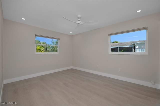 empty room with ceiling fan, light hardwood / wood-style flooring, and a wealth of natural light