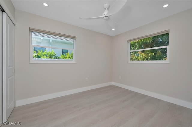 spare room with recessed lighting, baseboards, light wood-style floors, and a ceiling fan