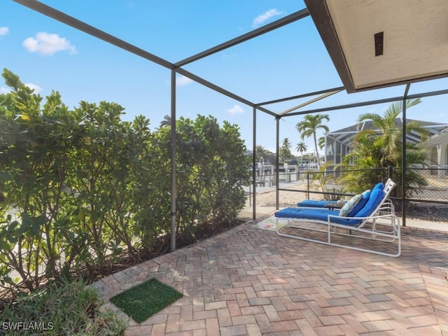 view of patio featuring a lanai