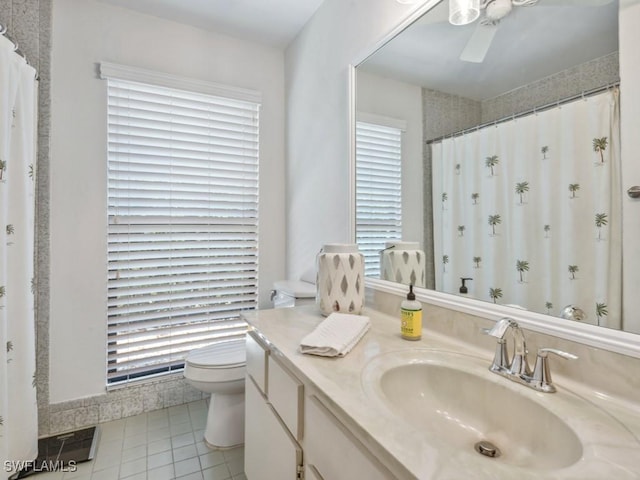 bathroom with tile patterned flooring, vanity, and toilet