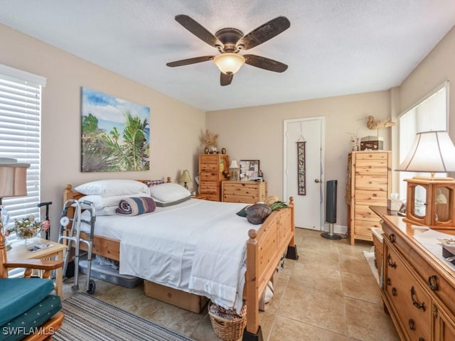 bedroom with ceiling fan and light tile patterned flooring