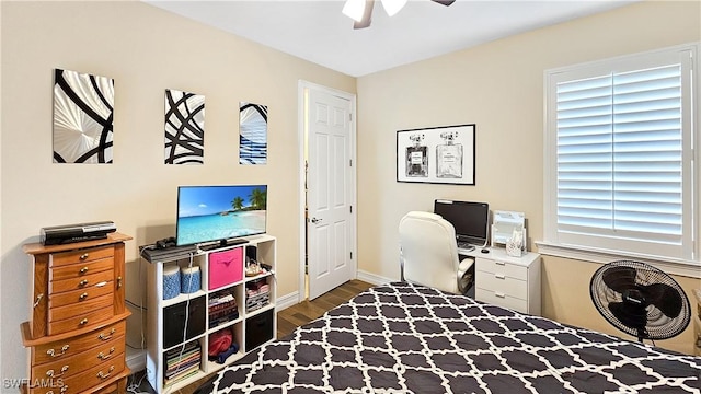 office space with ceiling fan, wood finished floors, and baseboards