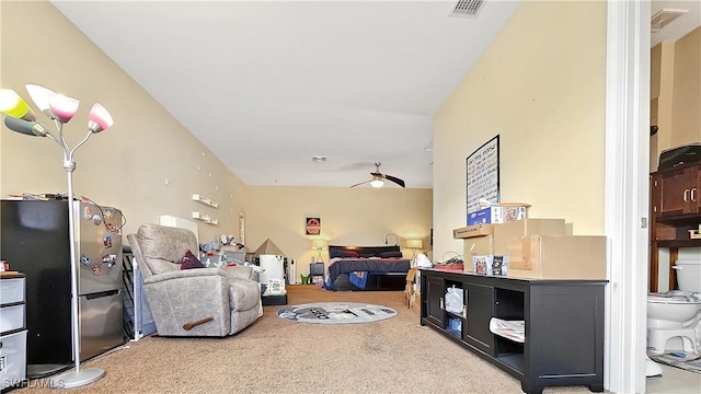 carpeted bedroom featuring freestanding refrigerator and visible vents