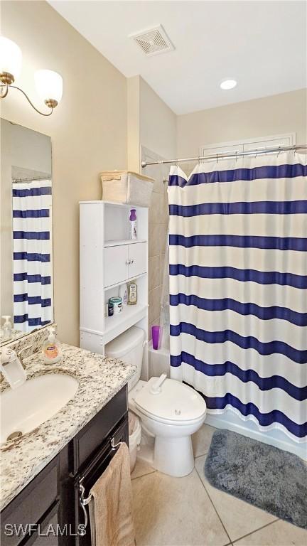 full bathroom with shower / tub combo with curtain, visible vents, toilet, vanity, and tile patterned floors