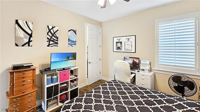 office featuring baseboards, a ceiling fan, and wood finished floors