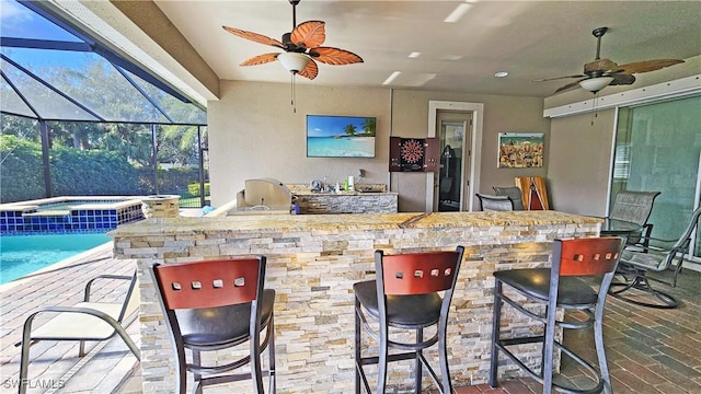 3240 Banyon Hollow Loop, North Fort Myers, FL 33903 - bar featuring a ceiling fan, a sunroom, and brick flooring