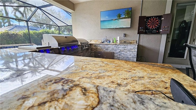 view of patio with a lanai, a grill, and area for grilling