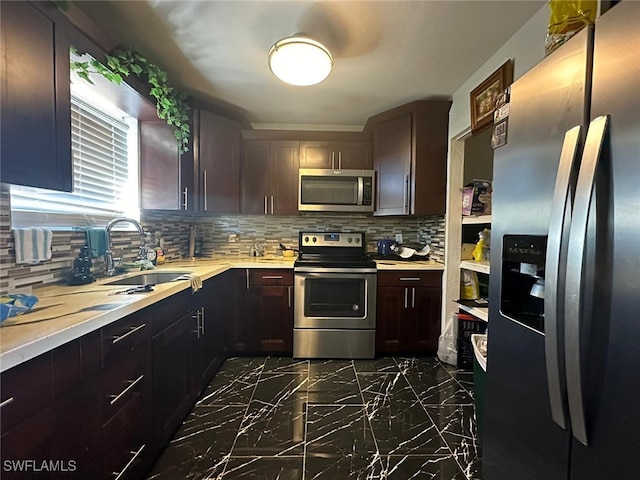 kitchen with decorative backsplash, dark brown cabinets, sink, and appliances with stainless steel finishes