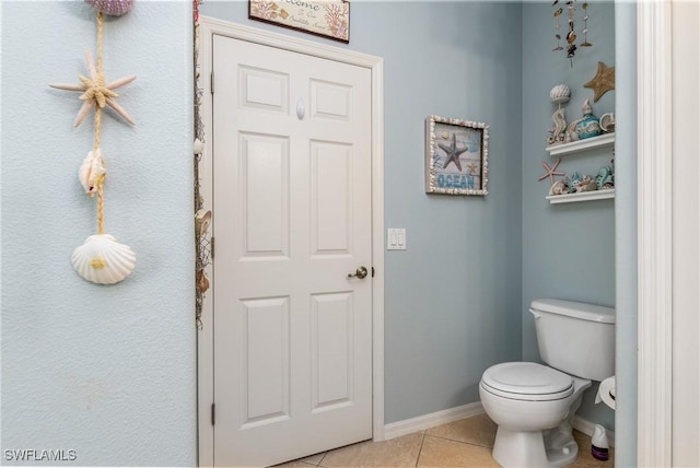 bathroom featuring tile patterned flooring and toilet