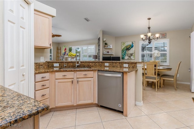 kitchen featuring an inviting chandelier, stainless steel dishwasher, kitchen peninsula, light brown cabinetry, and light tile patterned floors