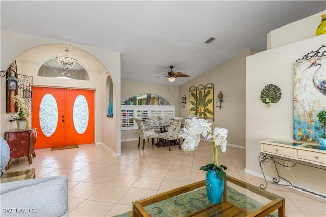 1427 SW 2nd St, Cape Coral, FL 33991 - entryway featuring arched walkways, light tile patterned flooring, a chandelier, and vaulted ceiling