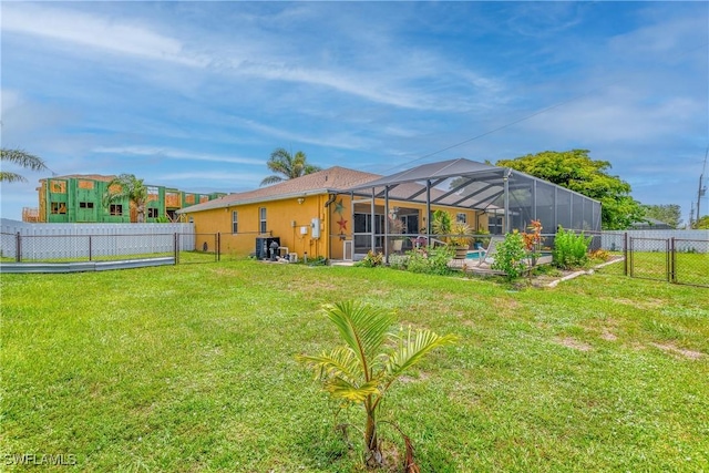 1427 SW 2nd St, Cape Coral, FL 33991 - rear view of property with a fenced backyard, a lanai, a swimming pool, and stucco siding