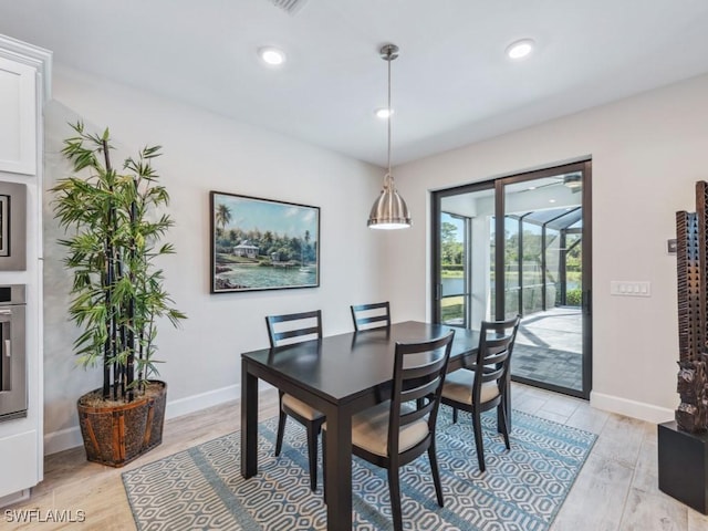 dining space featuring light wood-style flooring, baseboards, and recessed lighting