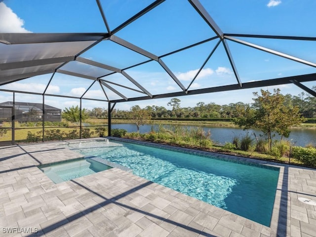 view of pool with a lanai, a patio area, a water view, and an in ground hot tub