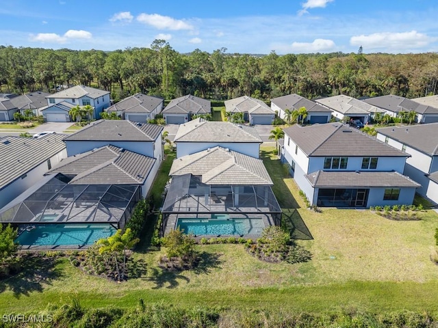 aerial view featuring a residential view and a view of trees