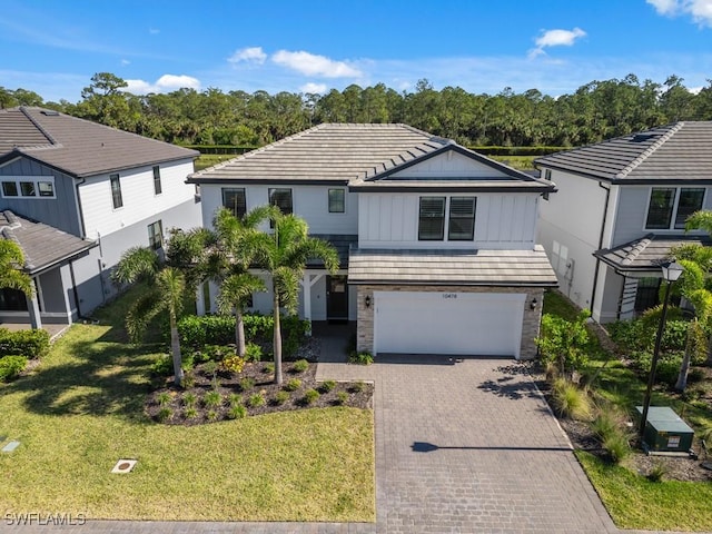 view of front of property featuring a garage and a front lawn