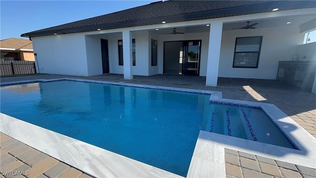 view of pool featuring a patio, ceiling fan, and exterior kitchen