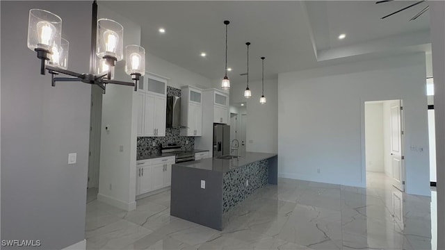 kitchen featuring decorative backsplash, appliances with stainless steel finishes, sink, pendant lighting, and white cabinets