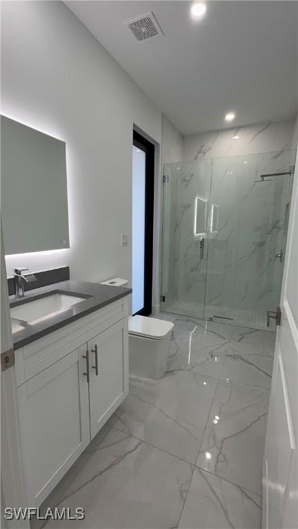 bathroom featuring vanity, toilet, and walk in shower