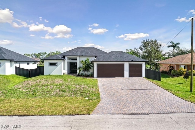 view of front of property featuring a front lawn and a garage