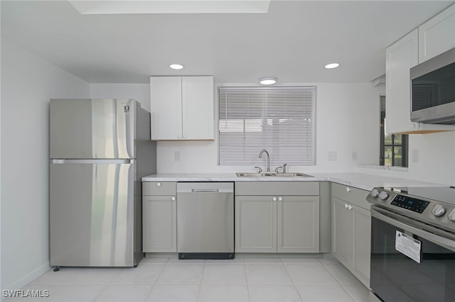 kitchen with light tile patterned flooring, stainless steel appliances, and sink