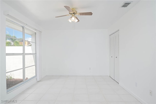 unfurnished room featuring ceiling fan and a healthy amount of sunlight