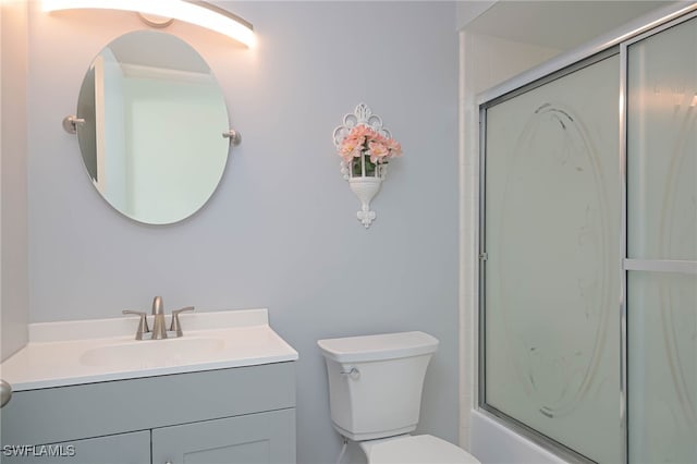 full bathroom with vanity, toilet, and bath / shower combo with glass door