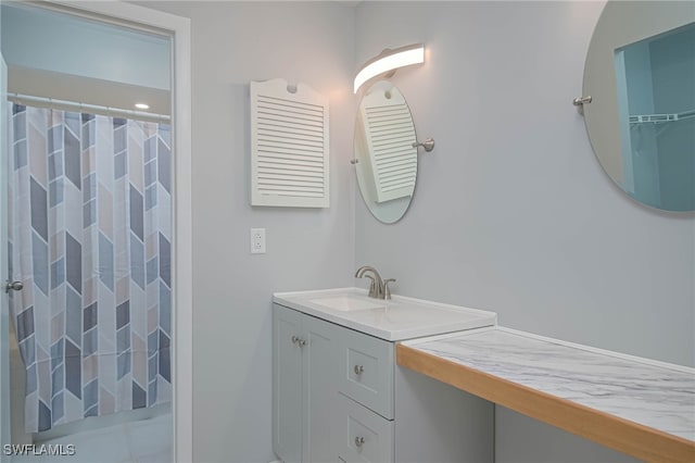 bathroom with vanity and curtained shower