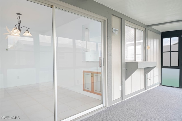 unfurnished sunroom with a chandelier