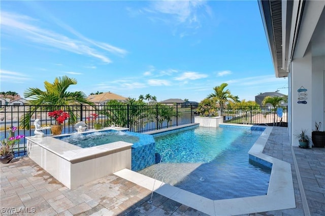 view of pool featuring pool water feature, a water view, and an in ground hot tub